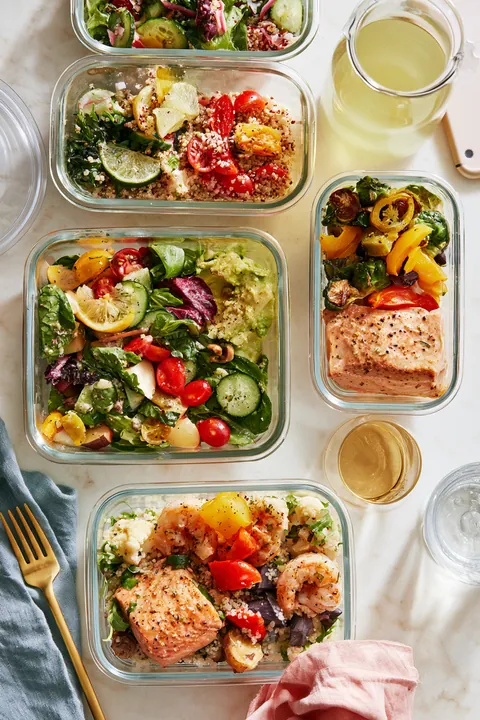 Top-down flat lay of colorful meal-prep containers on a kitchen counter, a budgeting habit Hidden Meadow Lending readers use to free up cash for debt payoff